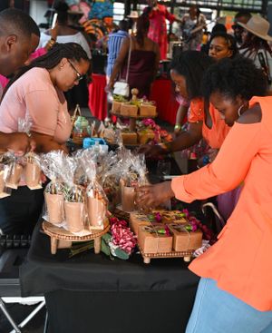 Vendors arranging gift baskets and merchandise at a market stall.