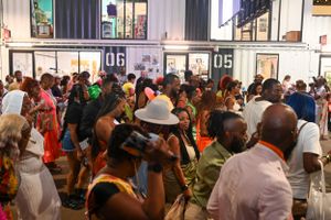 Crowded indoor event space filled with attendees enjoying a lively gathering.