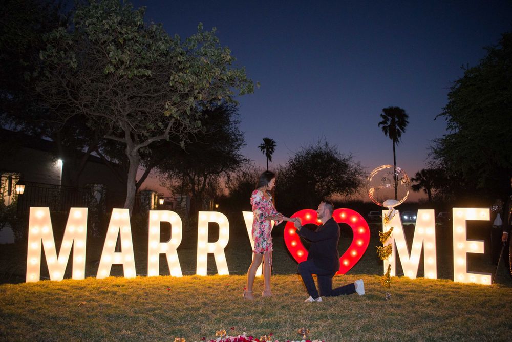 boyfriend kneeling down for proposal. Hacienda Las Mariposas. McAllen, Texas. Wedding photographer