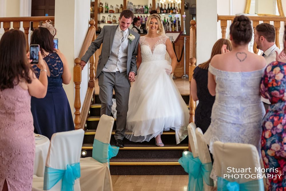 Bride and groom walk down the steps into the ballroom at west tower. Ormskirk wedding photographer. Lancashire wedding.