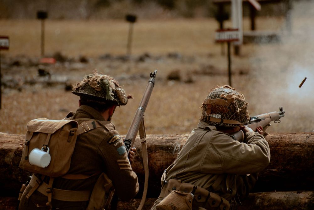 Military equipment and gear scattered across desert battlefield terrain.