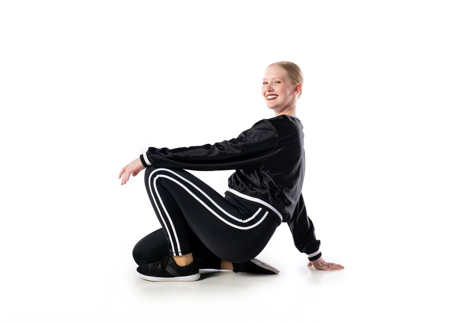 A senior hip hop dancer posing on a white backdrop