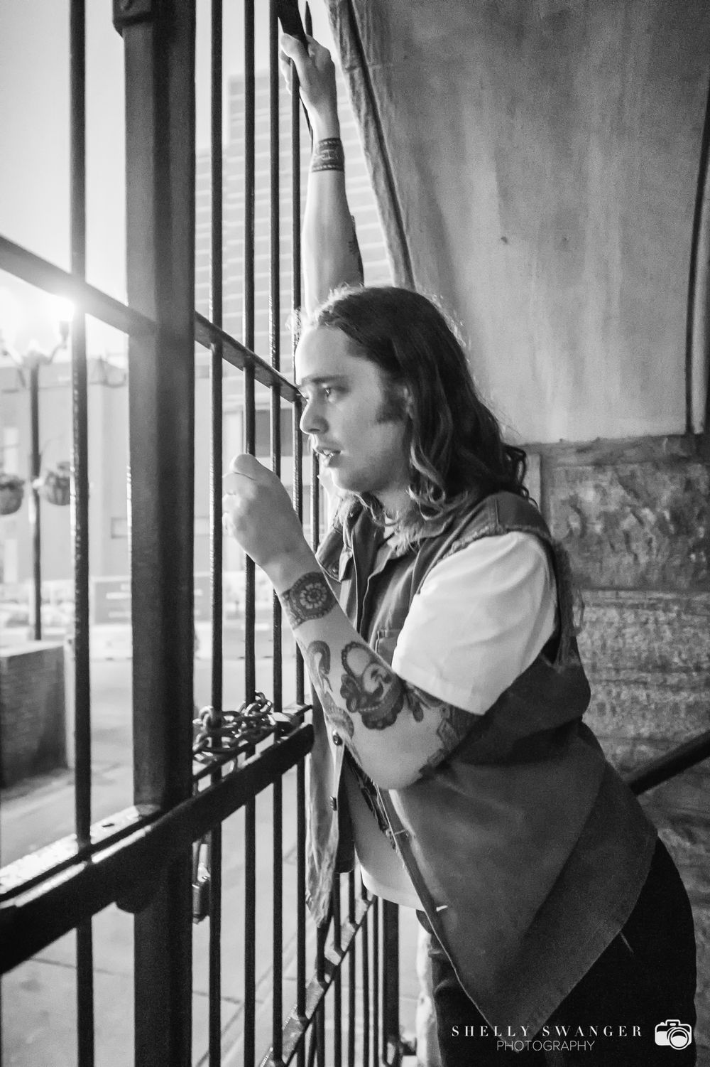 Dramatic black and white photo showing Billy Strings at the Ryman Auditorium in Nashville TN.