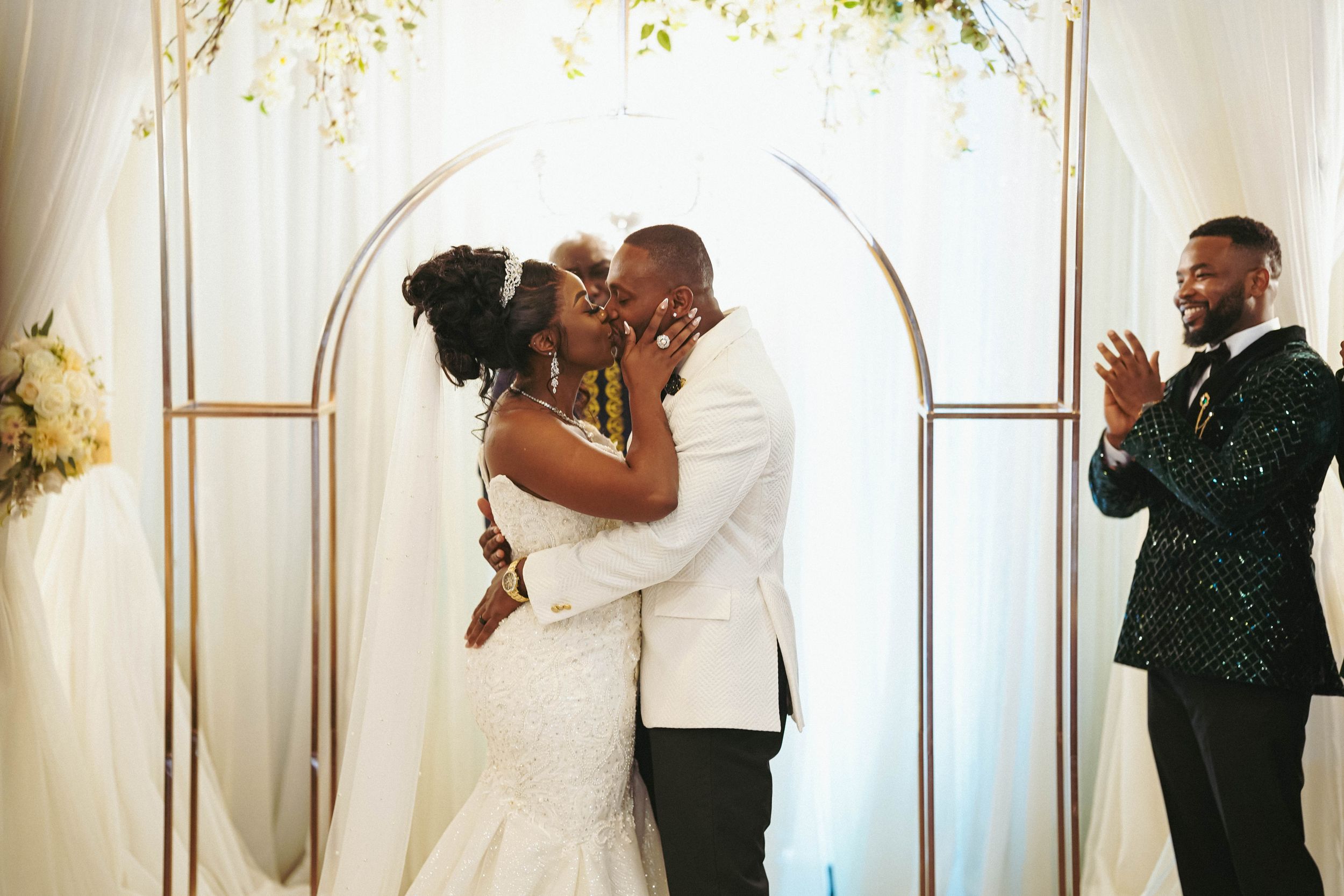 Wedding ceremony sequence showing celebratory moments under an elegant white arch with floral decor.