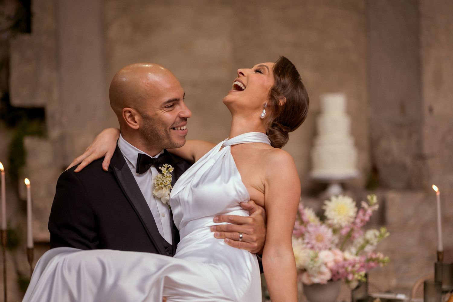 groom carrying bride laughing fairytale wedding