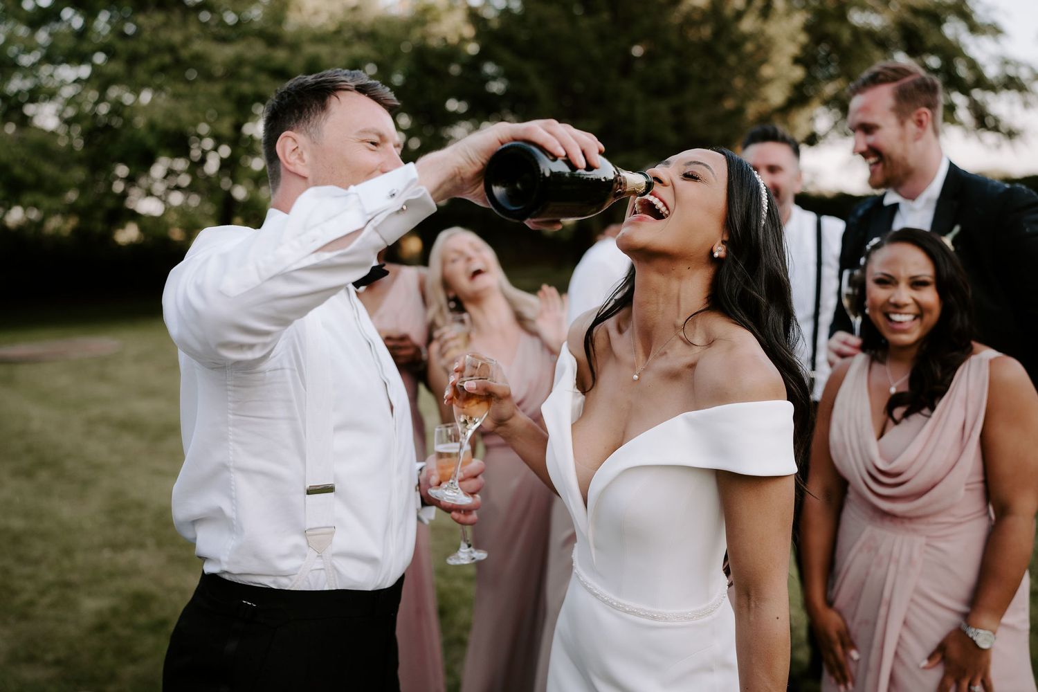 groom-pouring-champagne-into-brides-mouth-stockton-house-wedding-shropshire