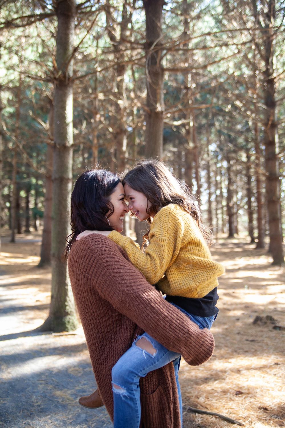 An intimate moment shared between two people in cozy sweaters against a forest backdrop.