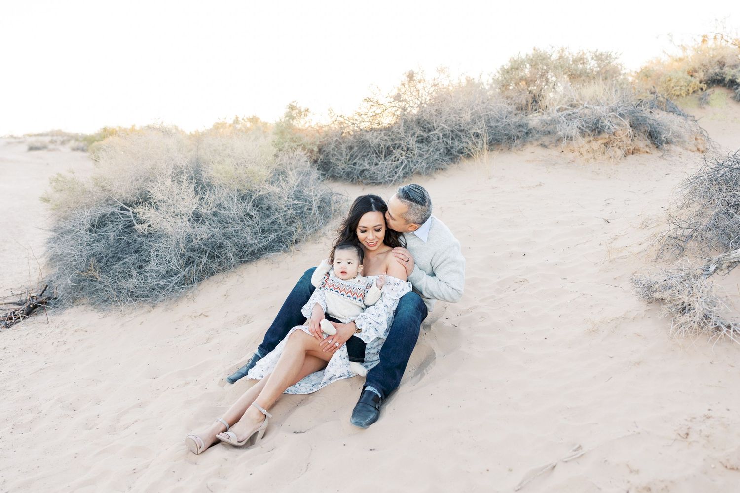 Romantic desert family photoshoot with soft golden light.