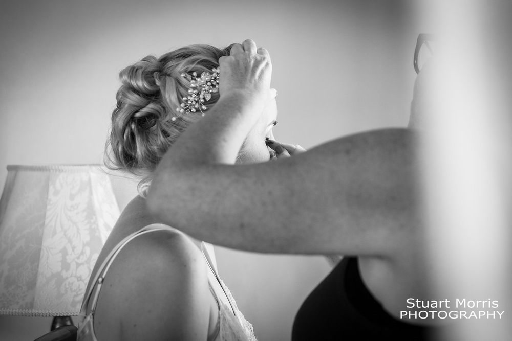 Bride having her makeup done on the wedding morning. West tower Aughton wedding venue. Lancashire wedding photographer.