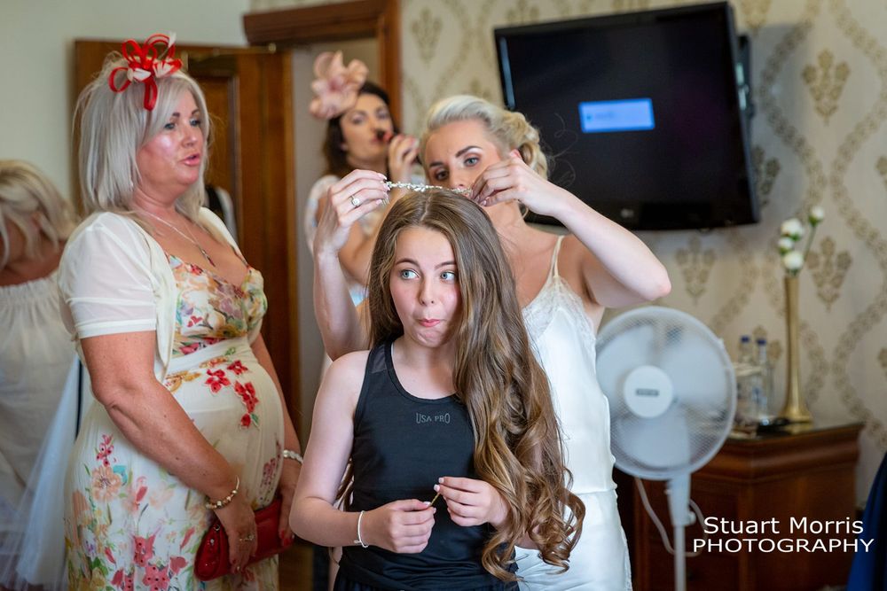Flower girl being fussed over on the wedding morning. West tower wedding photographer. Lancashire wedding photography