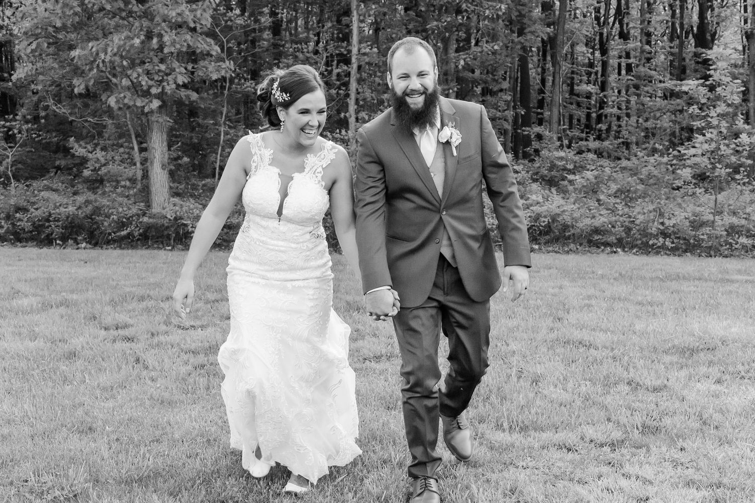 Black and white series of romantic wedding portraits captured in a natural outdoor setting.
