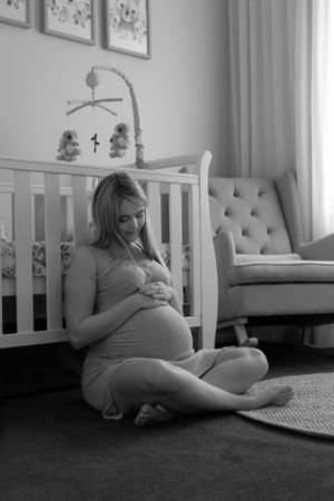 in-home lifestyle maternity session mother in nursery