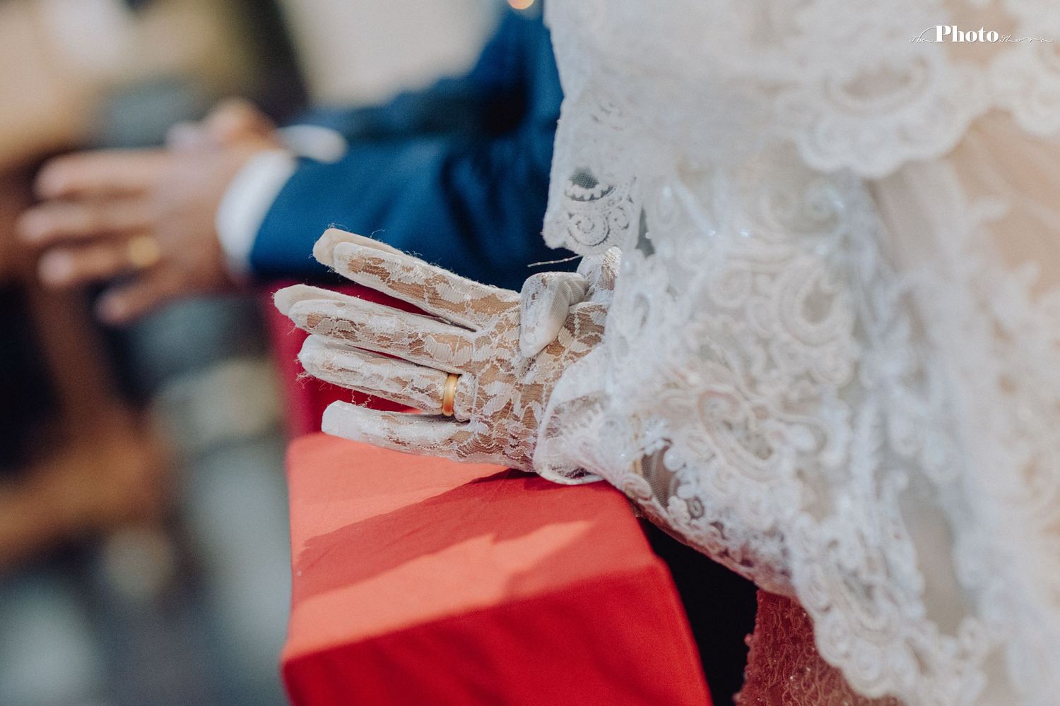 Close-up view of delicate white lace wedding dress details.