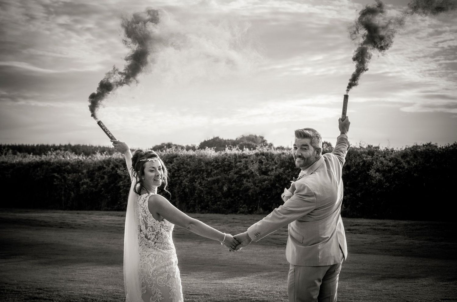 Black and white panoramic wedding photos showing a couple in an open field.