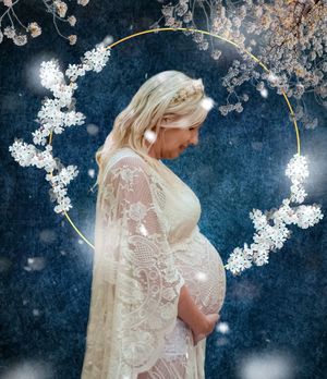 Ethereal white lace dress captured against dark background with delicate cherry blossoms.