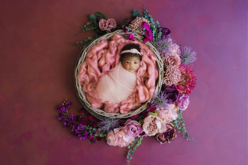 Newborn in pink flowers