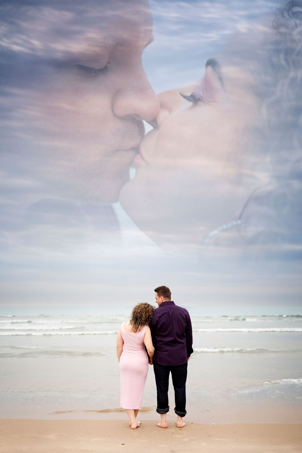 Two small figures in pink and purple outfits sitting together on a misty beach.