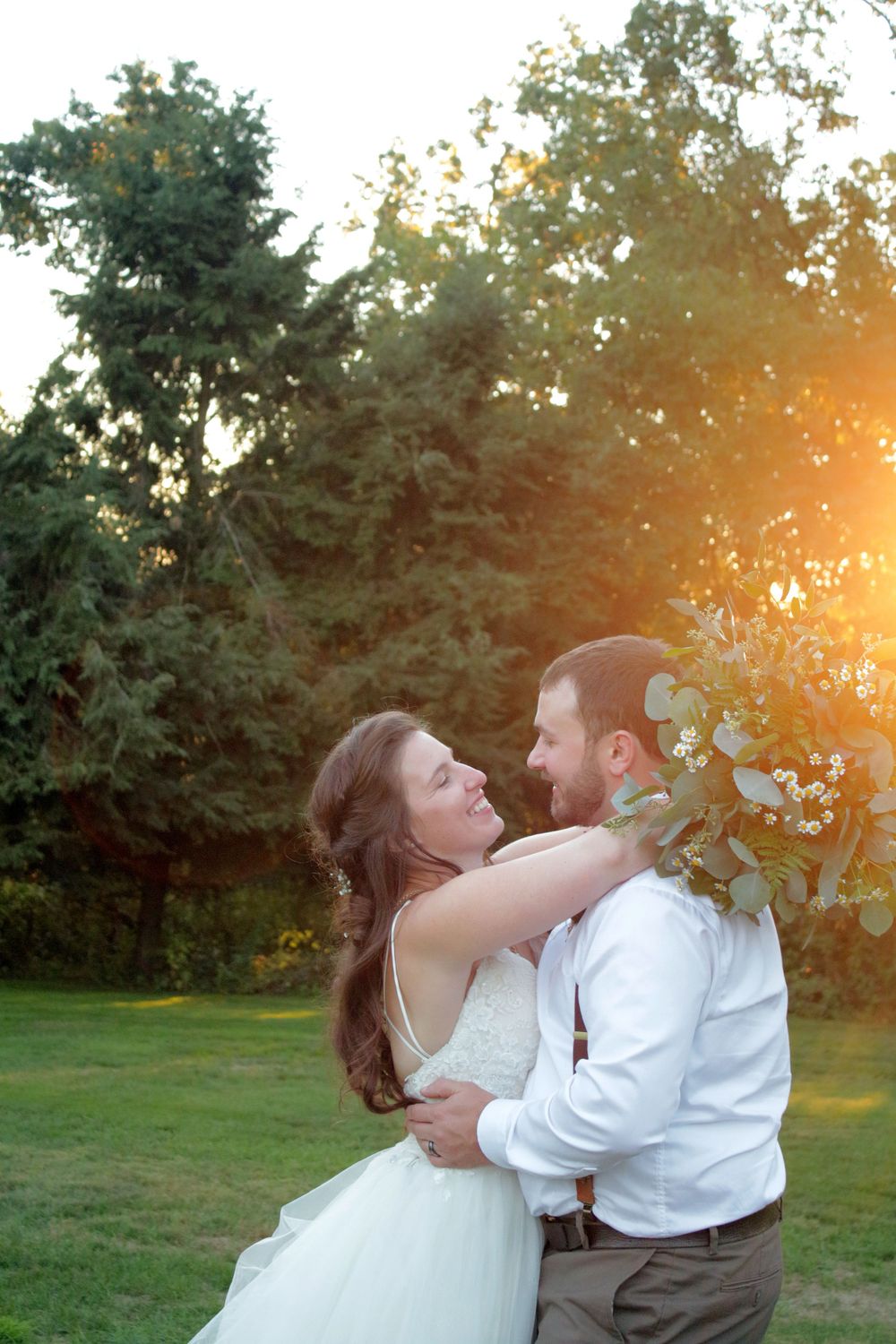 golden hour lens flare wedding bridal couple hugging lifestyle unposed