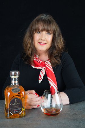lady sitting with a glass of whisky