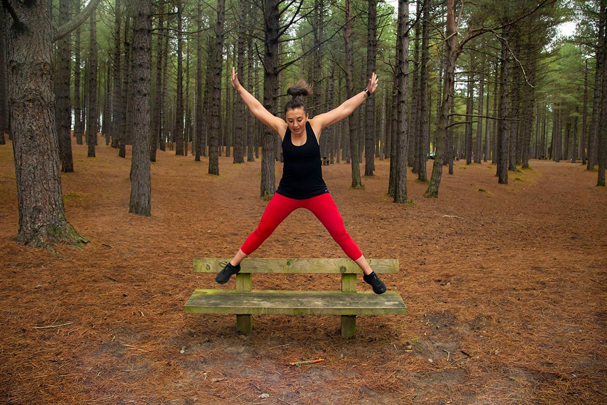 fitness lady doing star jumps