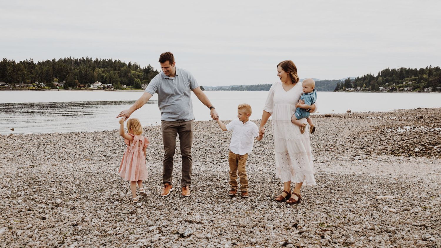 A warm and candid portrait of a couple/family, captured in natural light, with a timeless background.