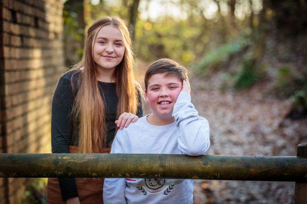 family photoshoot cousins pose in the countryside for a portrait photograph