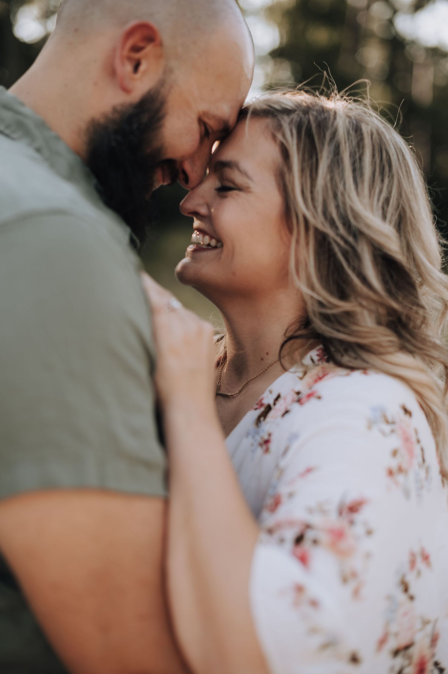 Close-up portrait of couple sharing an intimate laughing moment.