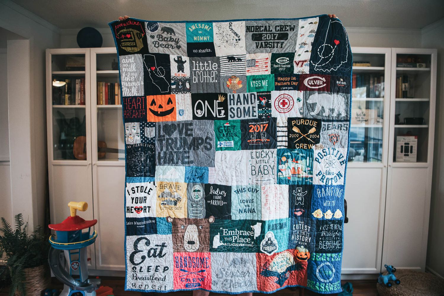 Patchwork memory quilt made with children's clothing and baby sleepers.