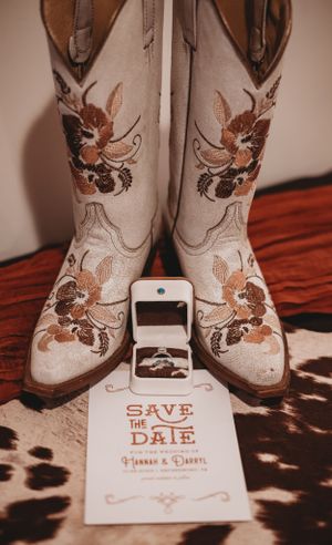 Embroidered cowboy boots with save the date wedding cards.