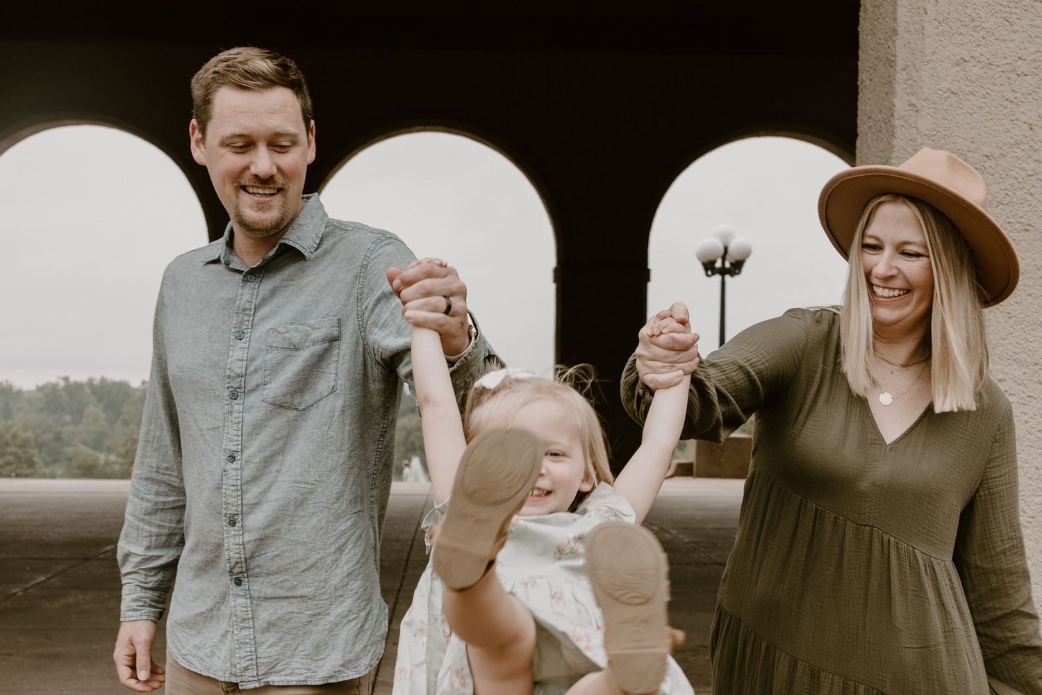 Candid family portrait in Joplin, Missouri captured in natural light by Modern Moods Imagery, showing genuine connection and movement.