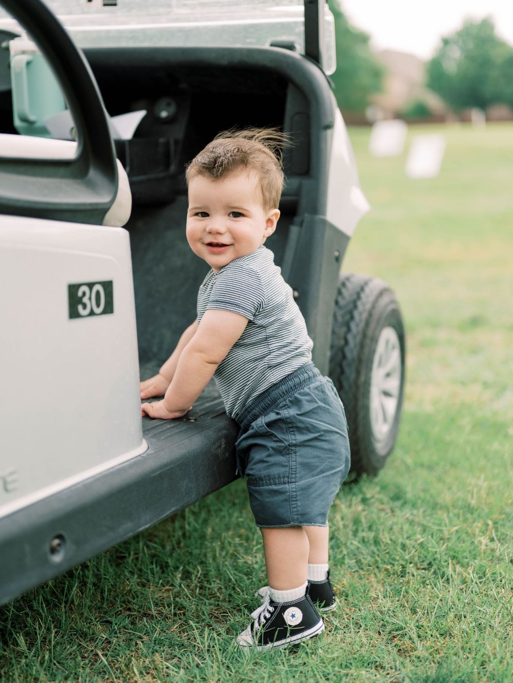 boy smiling with golf cart in Allen, TX
