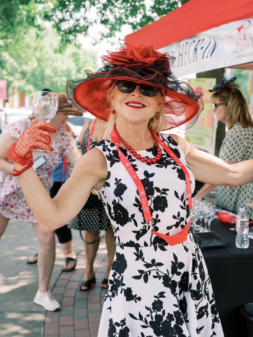 woman holding wine glasses in Downtown McKinney - Lone Star Wine Cellars