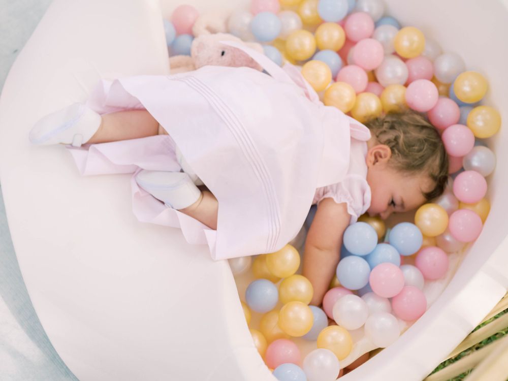 little girl in a ball pit