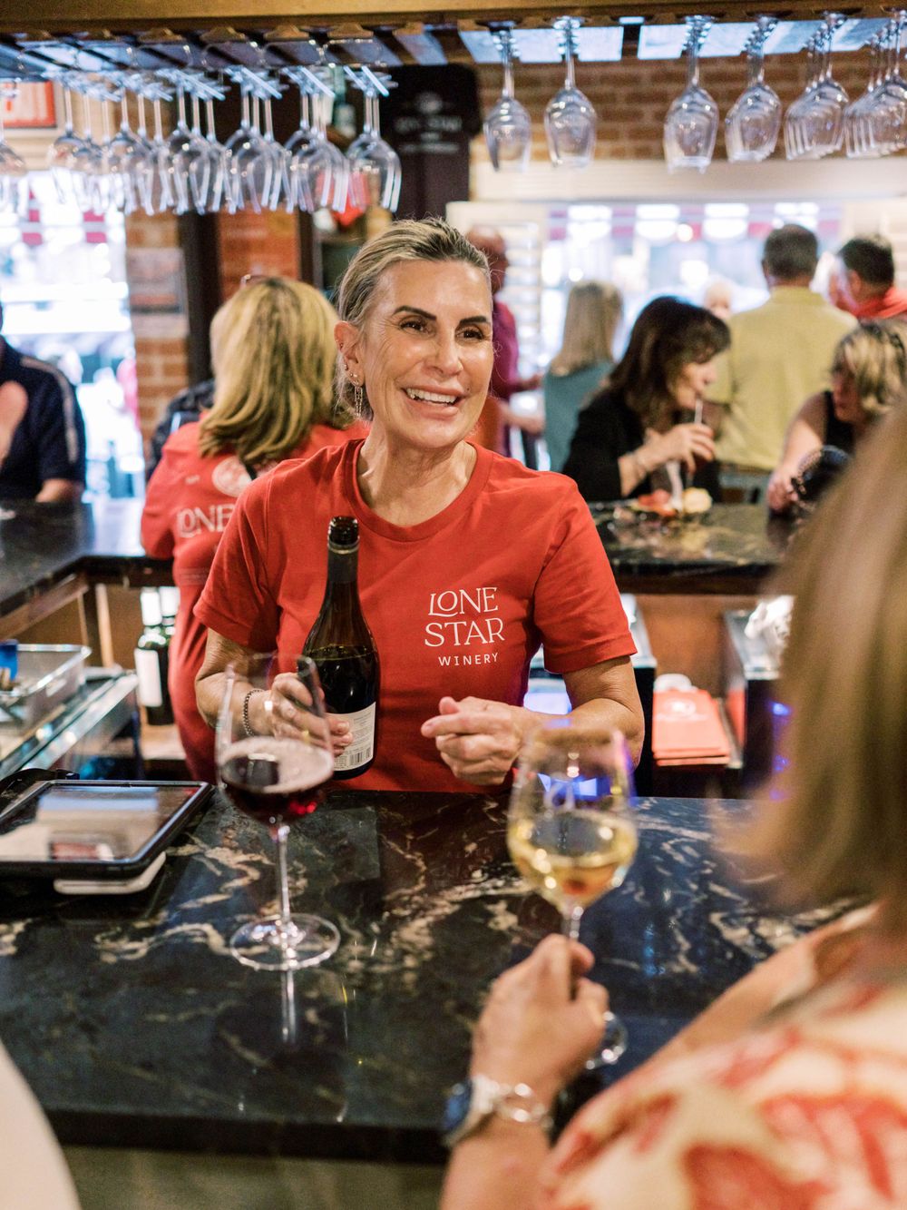 photo of a woman pouring wine at Lone Star Winery