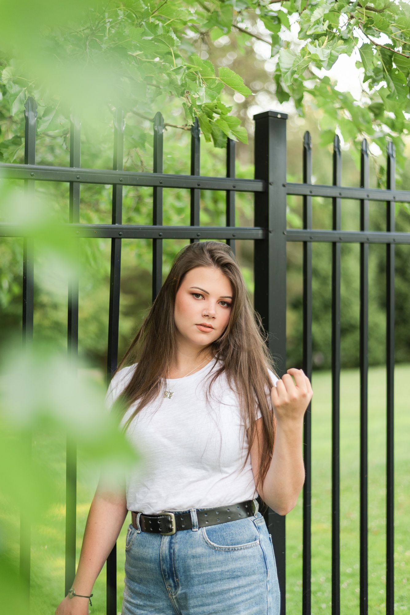 Young woman standing in front of gate at Hartwood Acres in Pittsburgh Pennsylvania