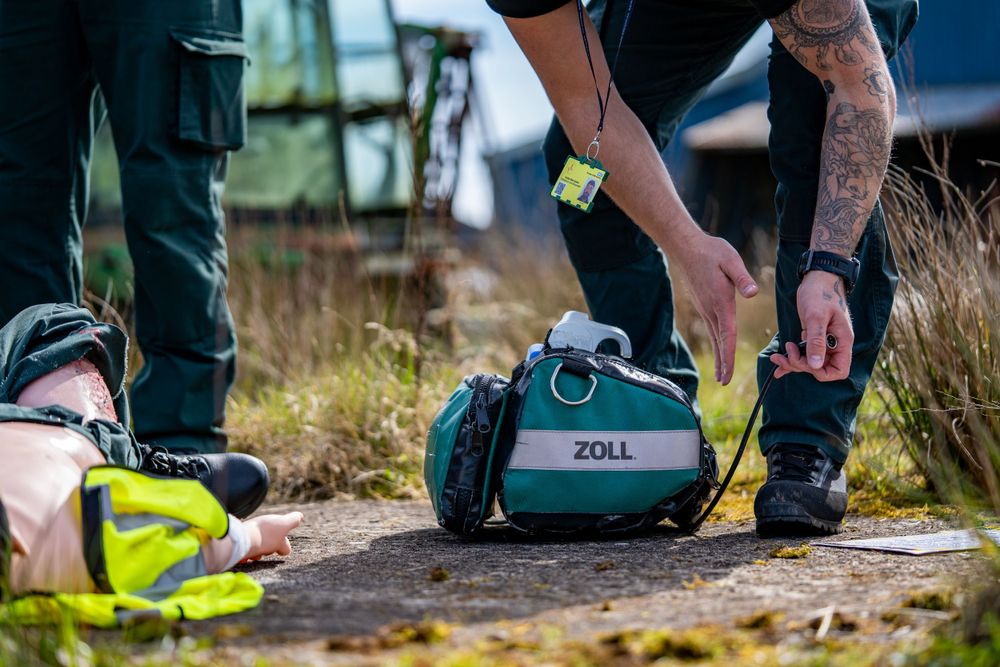 Close-up of emergency medical equipment and supplies being prepared outdoors.