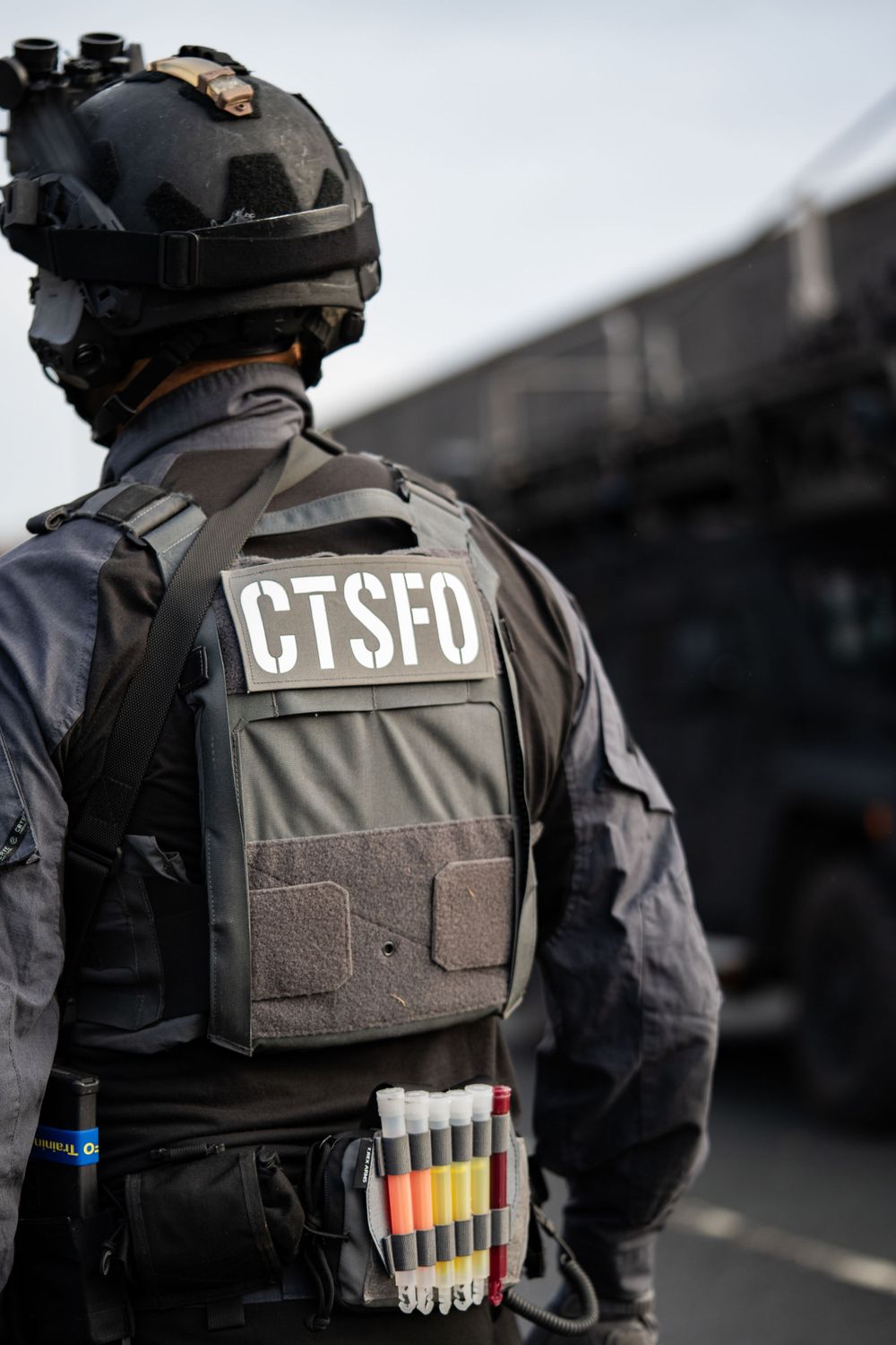 CTSFO tactical officer in protective gear with colorful markers attached to their vest.
