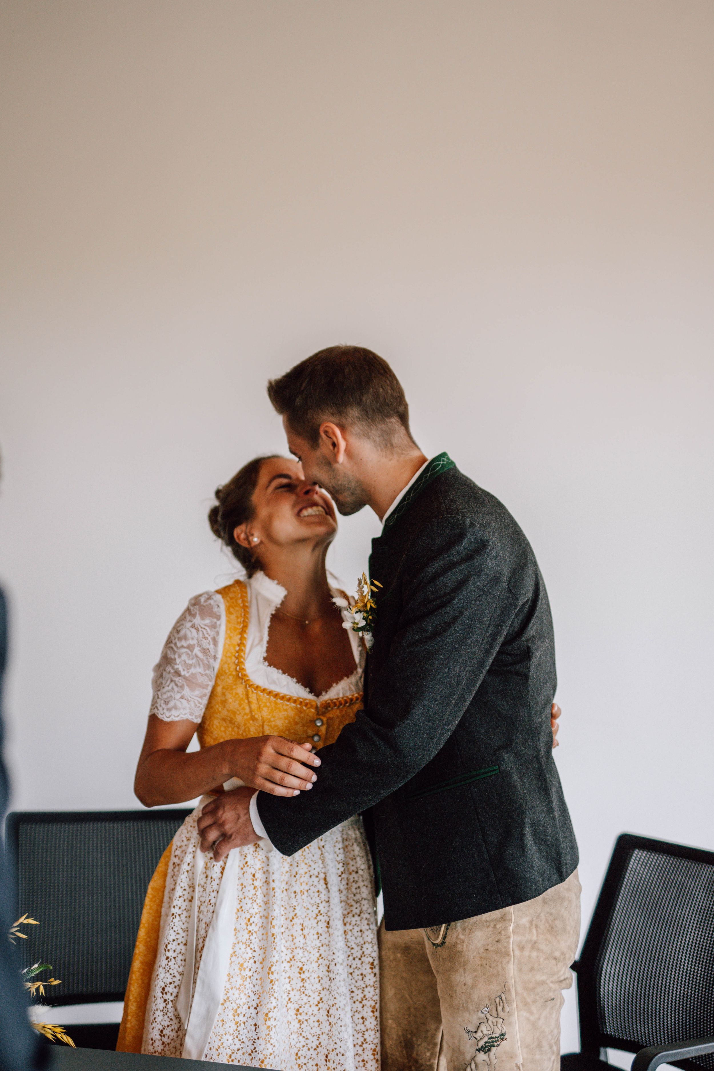 A sequence of tender moments between newlyweds against a neutral background.