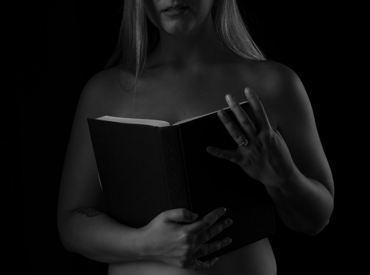 dark portraiture with a book as a prop
