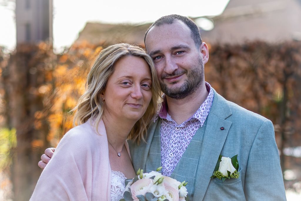 A romantic outdoor portrait of a couple on their wedding day during sunset.