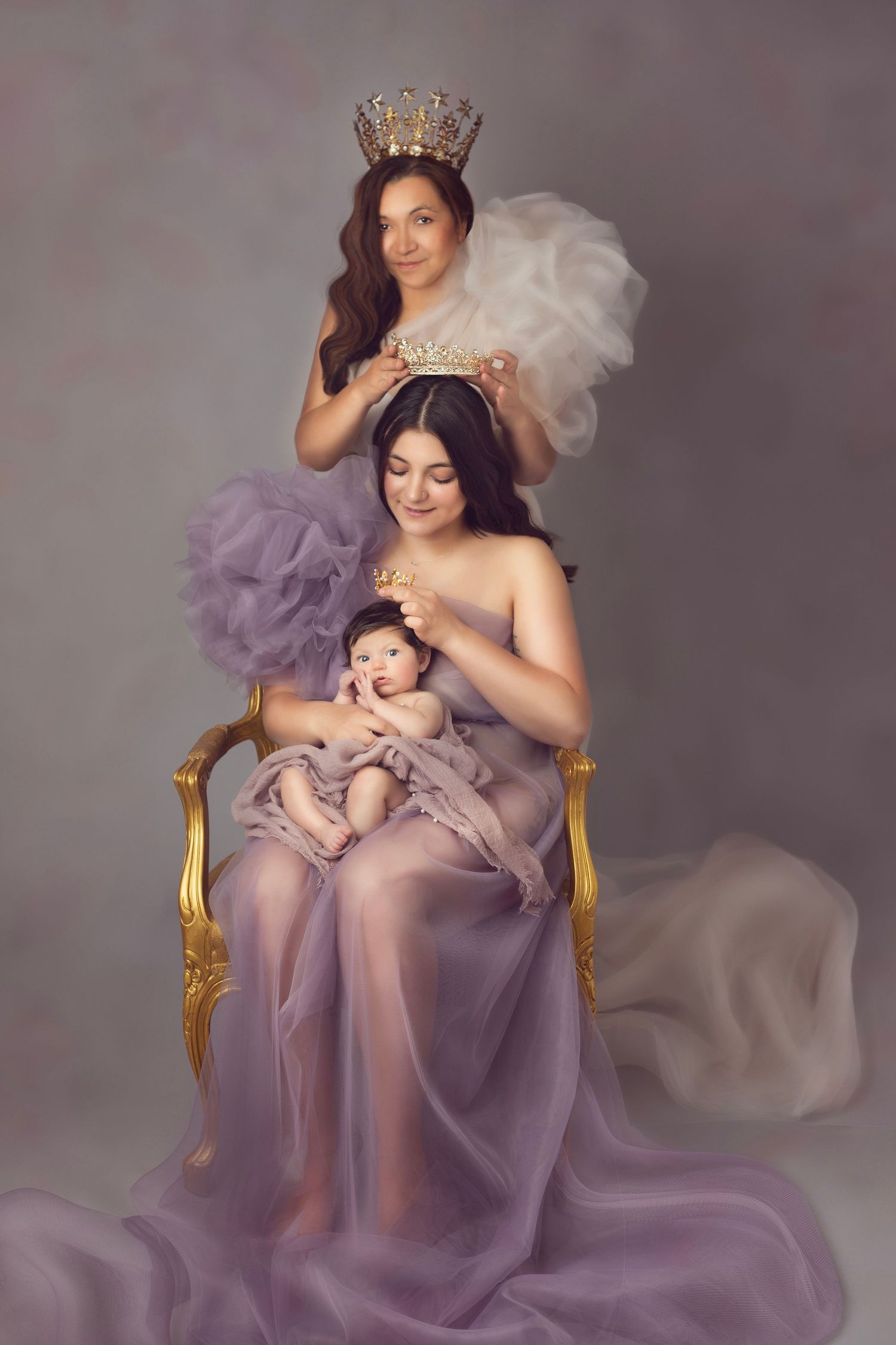 Ethereal maternity portraits in lavender gown with gold crown and chair.