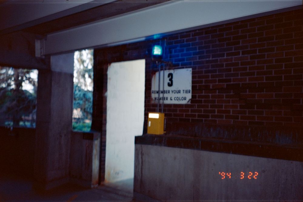 Dark interior hallway with brick walls and fluorescent lighting.