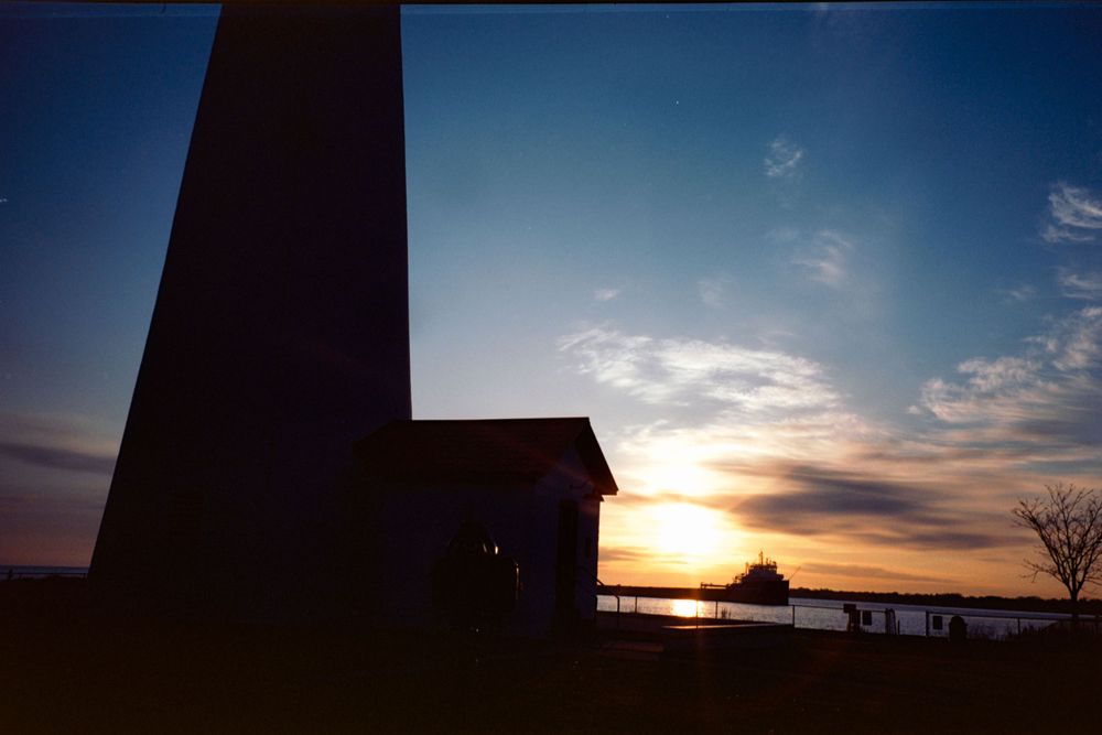 Silhouette of buildings against a deep blue twilight sky.