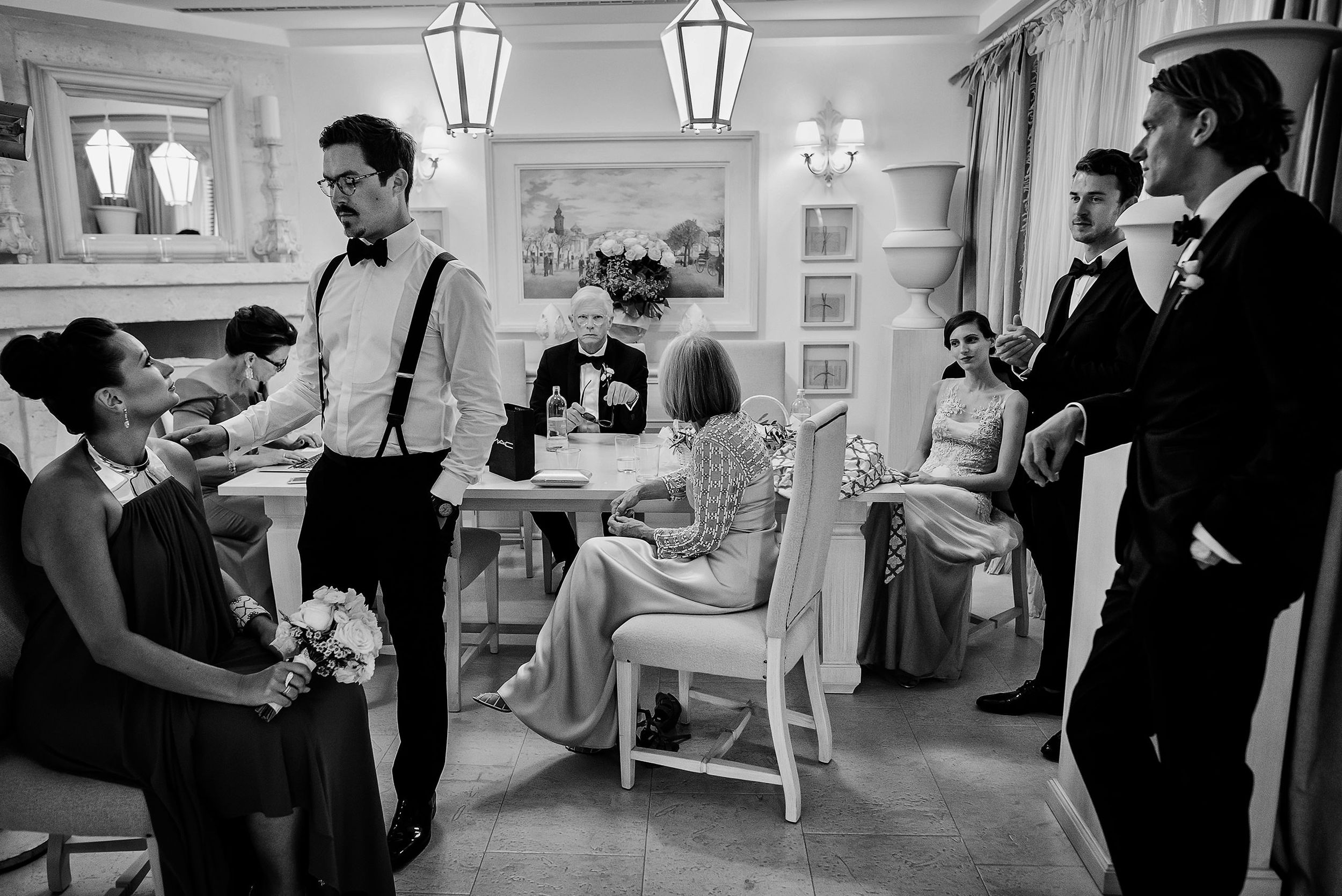 Elegant black and white photo of wedding preparations in a classic vintage-style room.