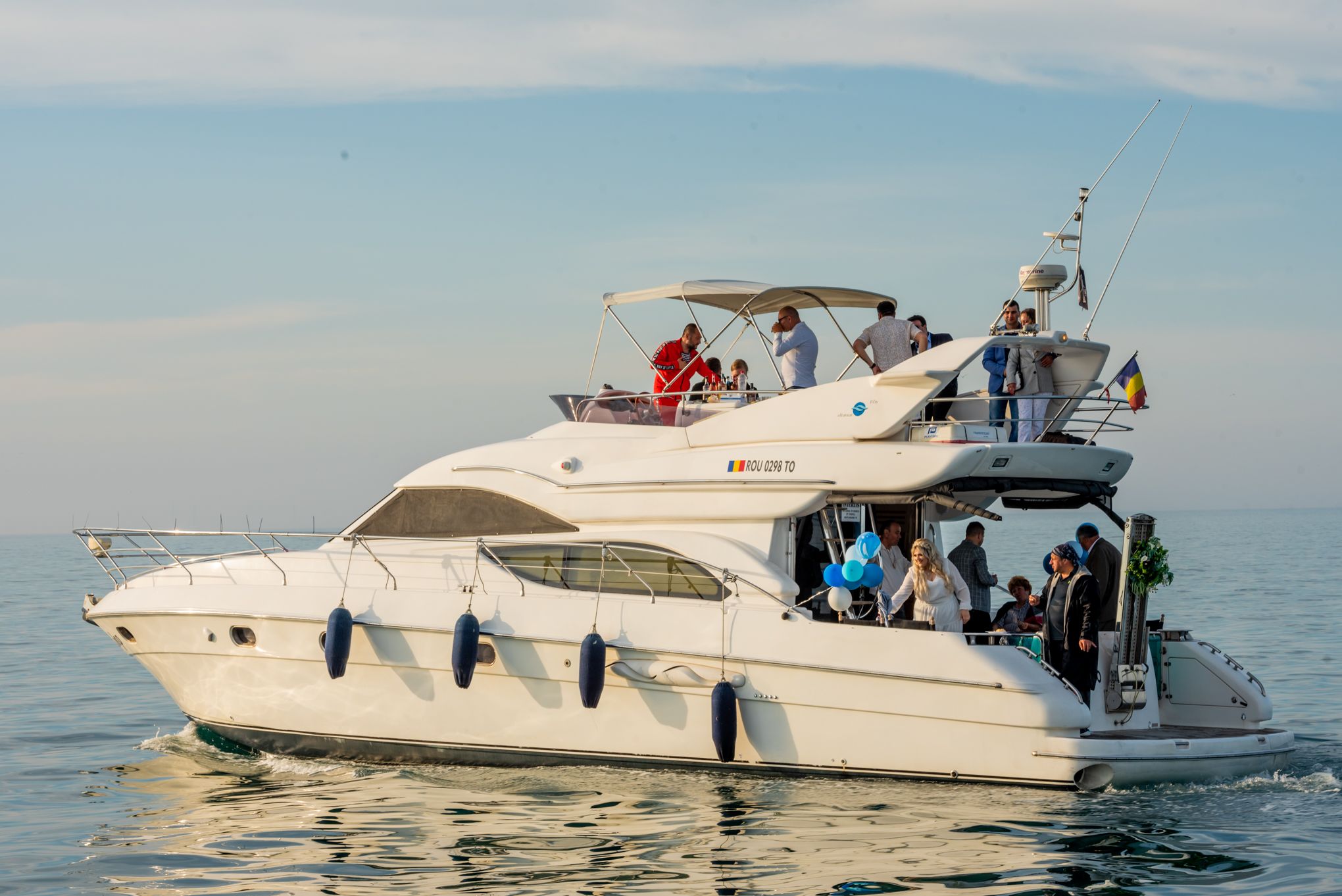 Luxury white yachts cruising together on calm ocean waters.