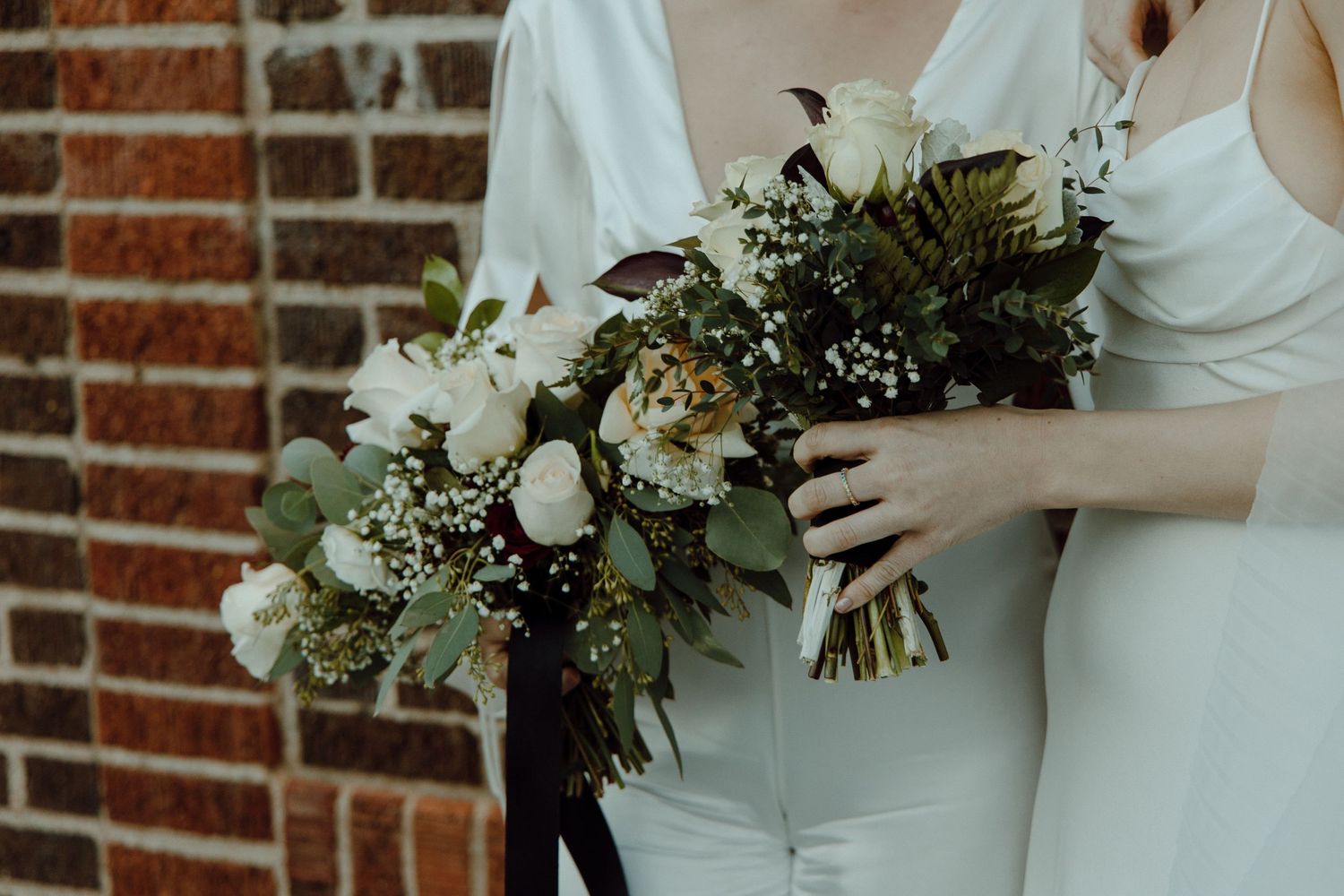 Two brides holding their bouquets