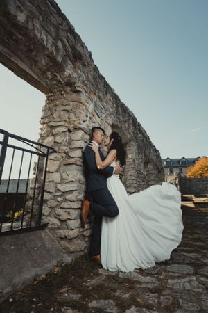 Bride and Groom hugging while wedding dress is flowing