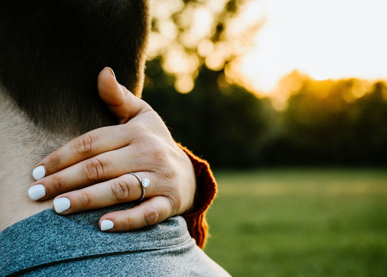 engagement ring with sunset in the background