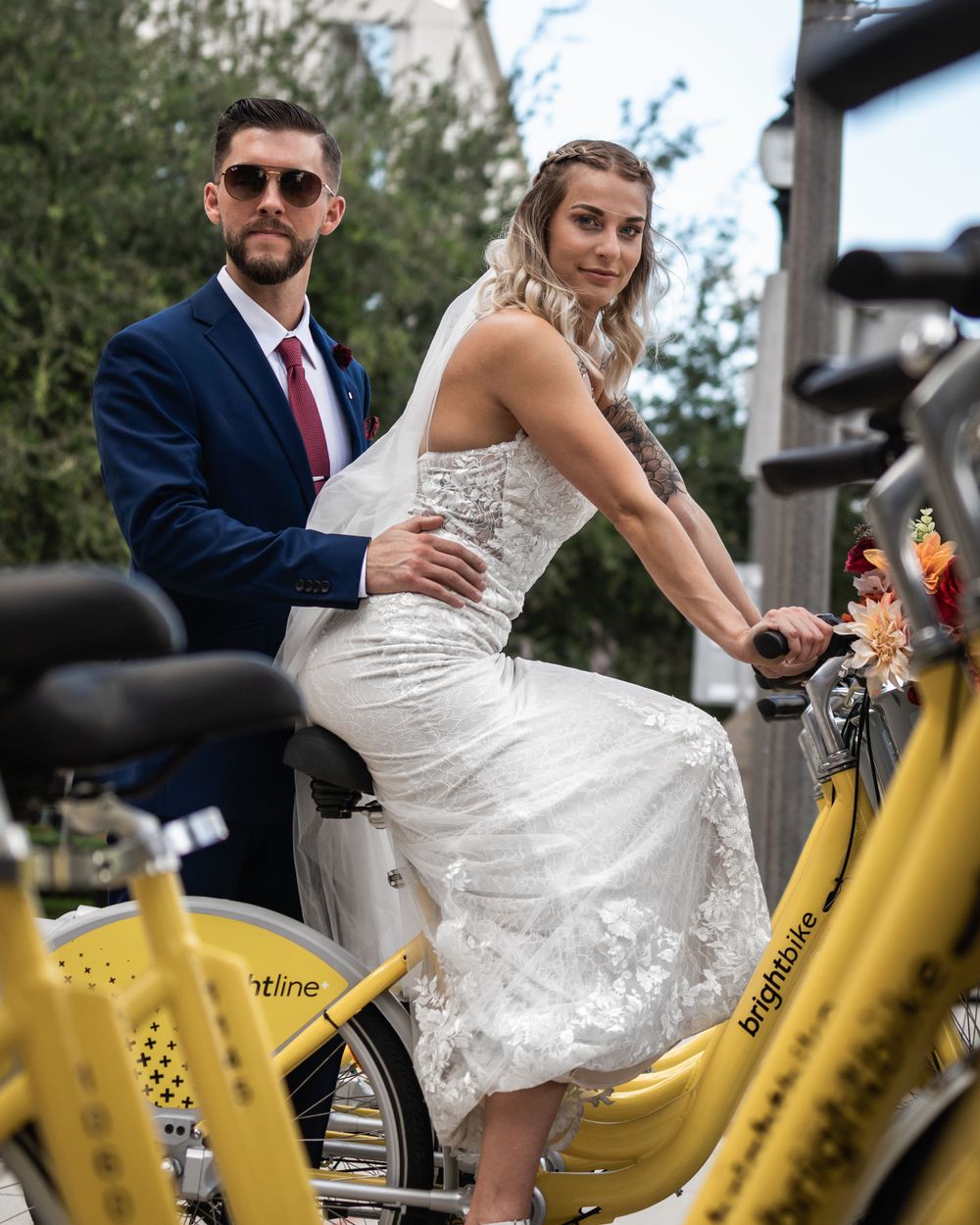 Wedding couple on yellow bicycles.