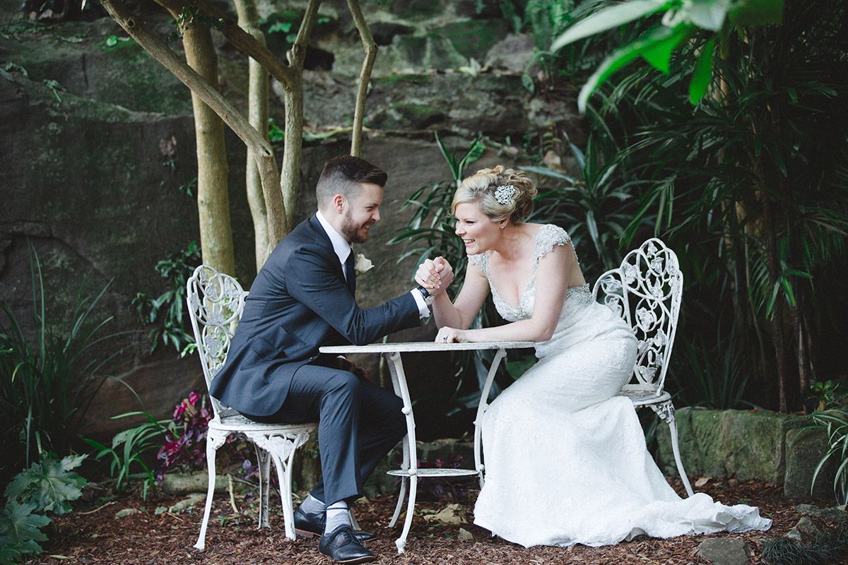 A romantic garden wedding photoshoot with vintage white furniture among lush greenery.